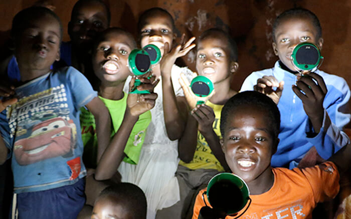 Childrens Holding Nokero Solar Powered Lamps