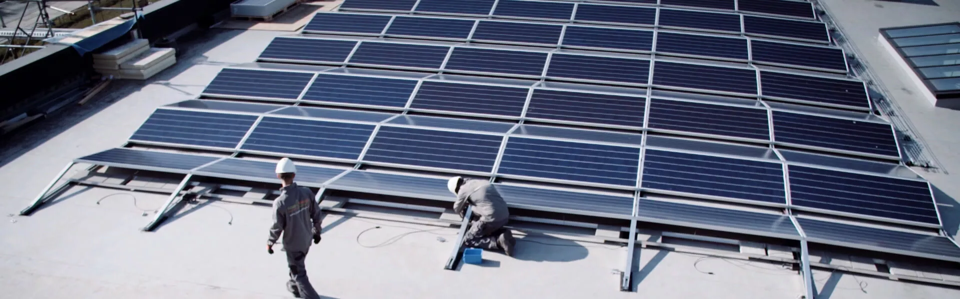 Developers on rooftop by solar panels