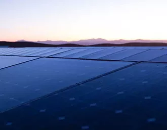 sunpower solar system with mountains and sunset