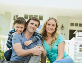 millenial family in front of their house